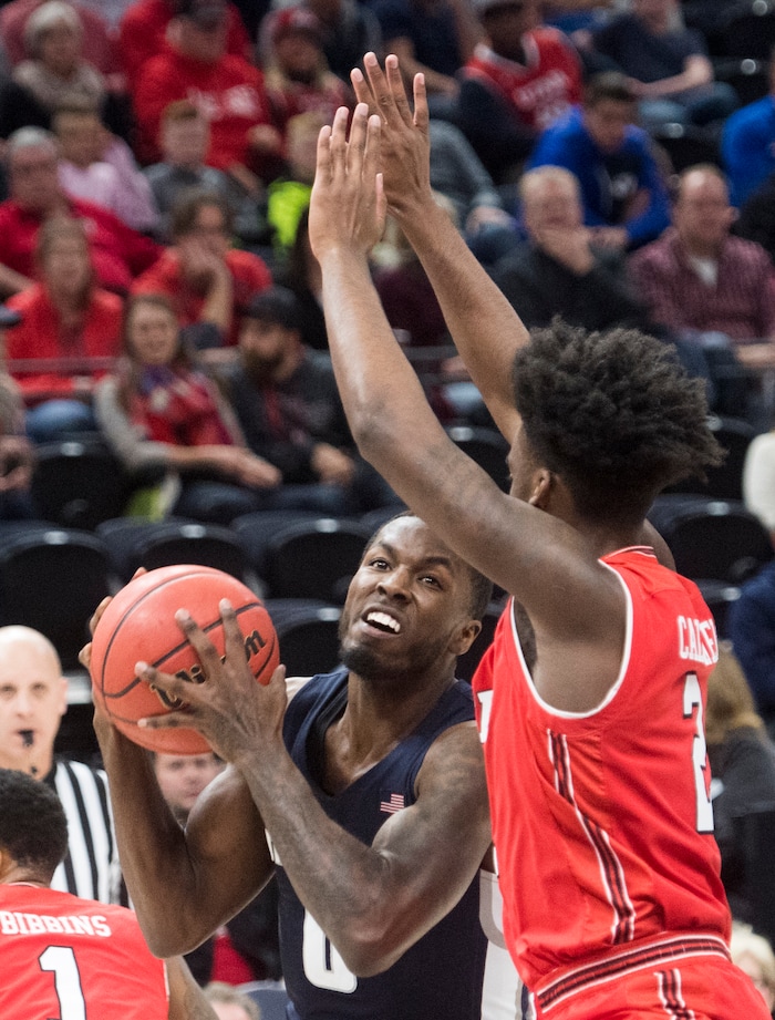 (Rick Egan  |  The Salt Lake Tribune) Utah State Aggies guard DeAngelo Isby (0) looks for a shot, as Utah Utes guard Kolbe Caldwell (2) defends, in Beehive Classic basketball action at the Vivint SmartHome Arena, Saturday, December 9, 2017.