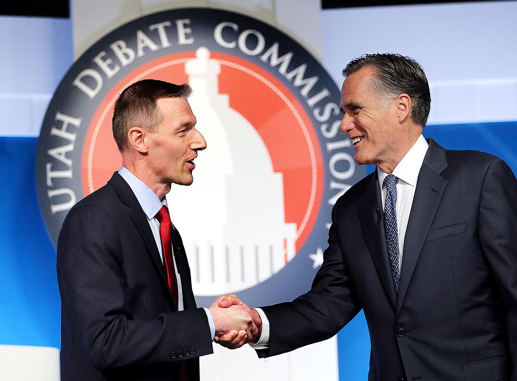 (Scott G Winterton | The Deseret News | The Associated Press) Utah Senate candidates state Rep. Mike Kennedy, R-Alpine, left, and former Massachusetts Gov. Mitt Romney shake hands at the beginning of a Senate Republican primary debate, Tuesday, May 29, 2018, in Provo.