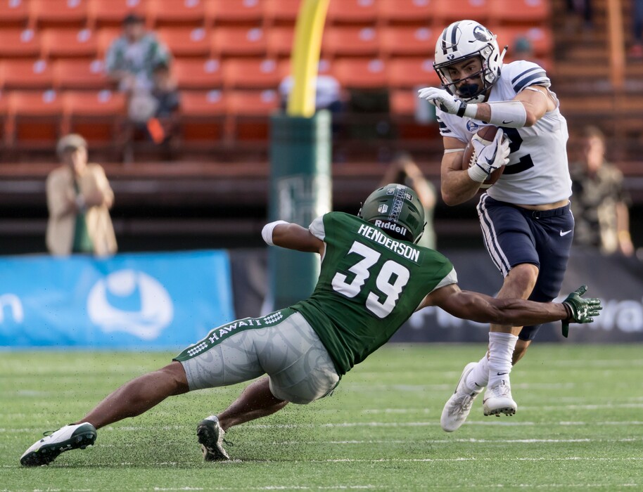 (Eugene Tanner | AP file photo) BYU running back Austin Kafentzis (2) attempts to get by Hawaii defensive back Trayvon Henderson (39) in the first quarter of an NCAA college football game, Saturday, Nov. 25, 2017, in Honolulu.