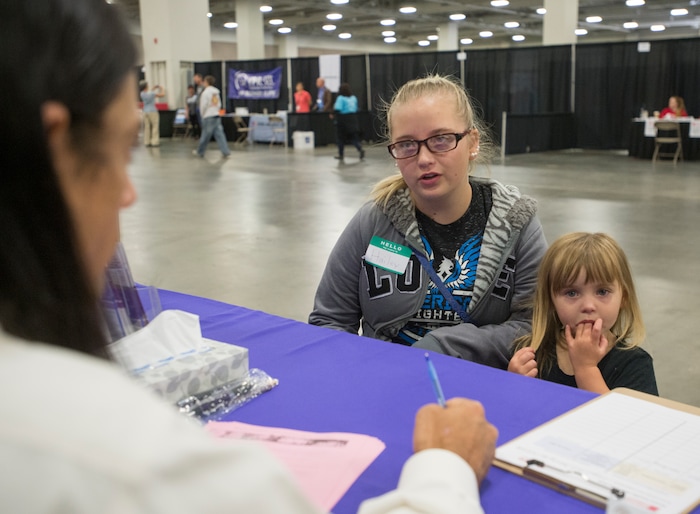 (Rick Egan  |  The Salt Lake Tribune)  Hailey Bartlett and her 3-year-old daughter, Abigail Fletcher, talk to legal help advisers during Project Homeless Connect on Friday, October 6, 2017. The one-day event in Salt Lake City brings together community volunteers to provide services for individuals and families experiencing homelessness.