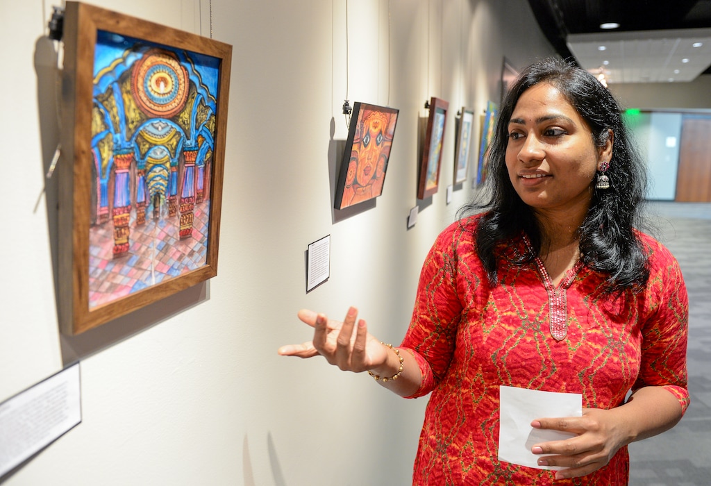 (Chris Samuels | The Salt Lake Tribune) Durga Ekambaram tours her artwork, stopping at the painting “Mysore Palace,” on display at the Utah Cultural Celebration Center in West Valley City, Friday, May 27, 2022.