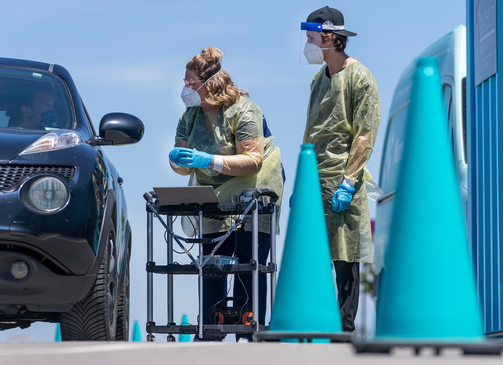 (Leah Hogsten | The Salt Lake Tribune) A registered nurse and a clinical assistant get nasal swabs and information from a family of four at the Nomi Health COVID-19 testing site in the parking lot of Amazon on Friday, June 10, 2022 in Salt Lake City.