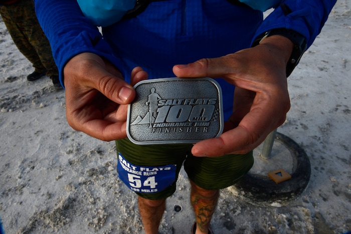 (Scott Sommerdorf | The Salt Lake Tribune)
Alex Doolan, shows off the belt buckle he was given for finishing the Salt Flats 100 Endurance Run in 8th place, Saturday, May 5, 2018.
