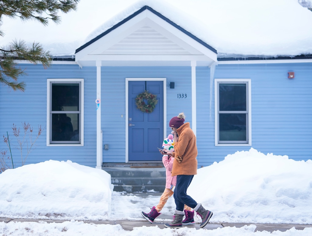 (Bethany Baker | The Salt Lake Tribune) Two people walk along the sidewalk in Old Town Park City on Thursday, Feb. 22, 2024. Housing in the resort town is getting more expensive, and lucrative short-term rentals are leaving few options for traditional renters, including firefighters, teachers and service industry workers.