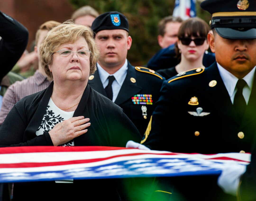 (Rick Egan  |  The Salt Lake Tribune)     Mary Ann Turner, the daughter of 2nd Lt. Lynn W. Hadfield, watches the Honor Guard fold up the American flag during the graveside service for her father, who was killed during the Second World War, at Veterans Memorial Park, in Bluffdale. Thursday, March 21, 2019.