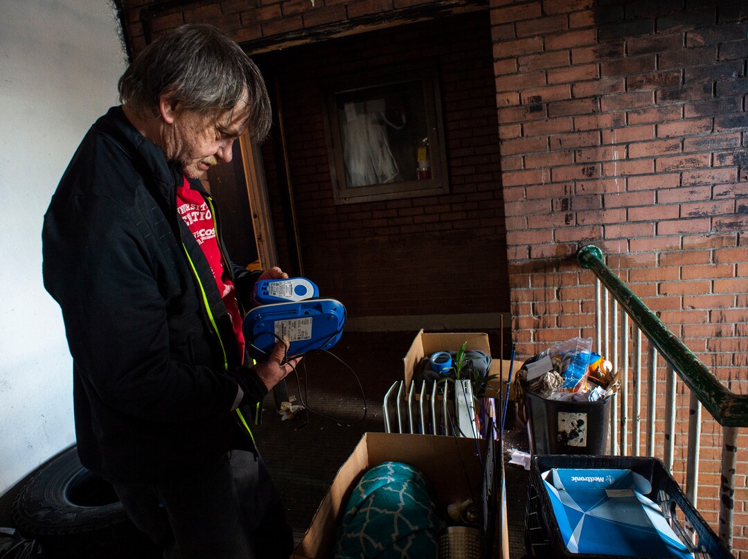 (Rick Egan | The Salt Lake Tribune)   Dan Marcotte, holds his heart monitor, that must be plugged in, as he stands with his belongings outside his apartment, while he tries to figure out where he will live, less than an hour before the deadline to leave the Georgia apartment complex, Saturday, Feb. 16. 2019