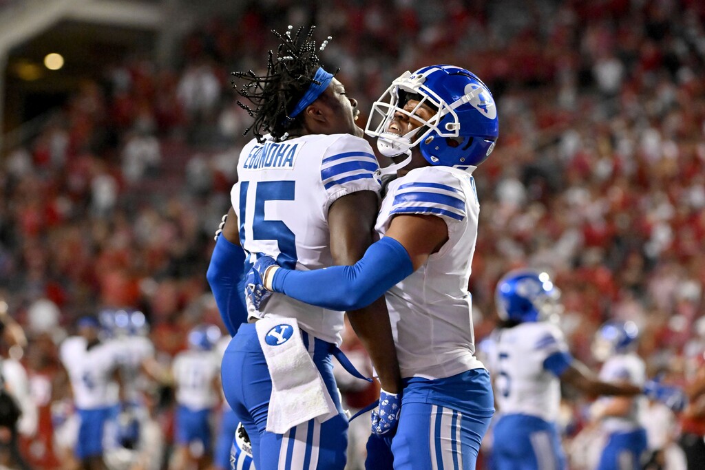 (Michael Woods | AP) BYU defensive backs Chika Ebunoha (15) and Kamden Garrett (7) celebrate after stopping Arkansas on the final play, giving BYU a win in an NCAA college football game Saturday, Sept. 16, 2023, in Fayetteville, Ark.