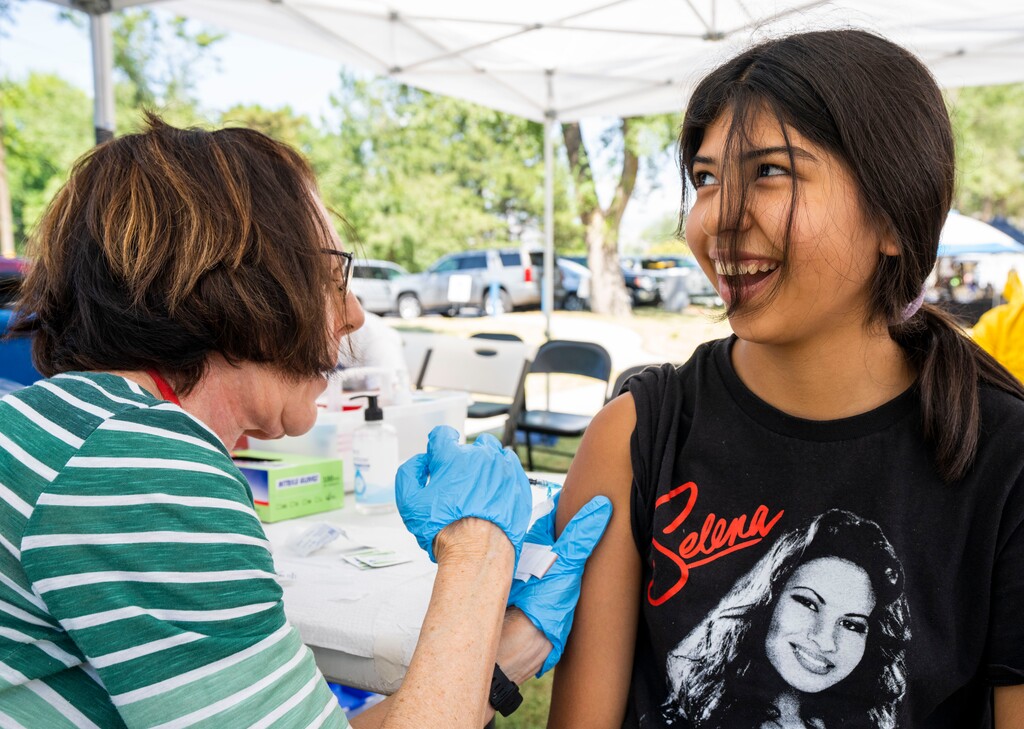 (Rick Egan | The Salt Lake Tribune)  Donna Nicholson administers a Covid-19 vaccination to 14-year-old Iris Miranda, at the Friendly Islands Tongan Festival, at Jordan Park, on Friday, Aug. 13, 2021.
