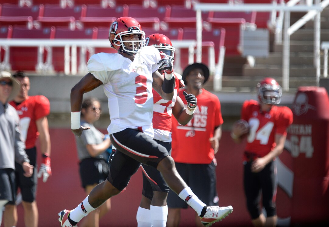 Scott Sommerdorf   |  The Salt Lake Tribune  Utah QB  Troy Williams high-steps down the field to join in the celebration with WR Tyrone Smith after connecting with Smith on a long 4th down pass play during practice, Thursday, August 11, 2016. 