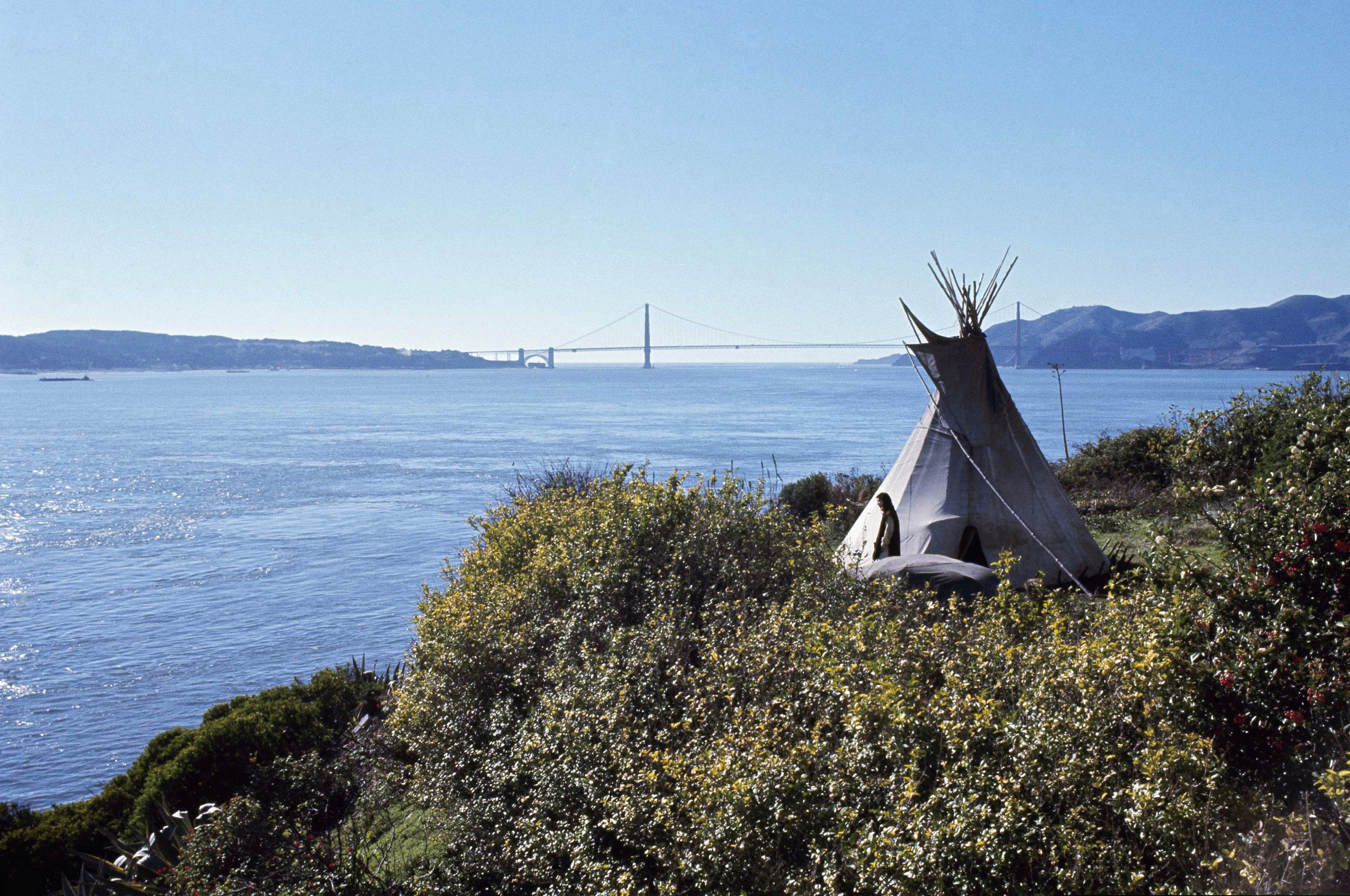 (AP file photo) In this Nov. 18, 1970, file photo, Sioux Indian John Trudell stands next to the teepee he set up for himself during the Native American occupation of Alcatraz Island. The week of Nov. 18, 2019, marks 50 years since the beginning of a months-long Native American occupation at Alcatraz Island in the San Francisco Bay. The demonstration by dozens of tribal members had lasting effects for tribes, raising awareness of life on and off reservations, galvanizing activists and spurring a shift in federal policy toward self-determination.