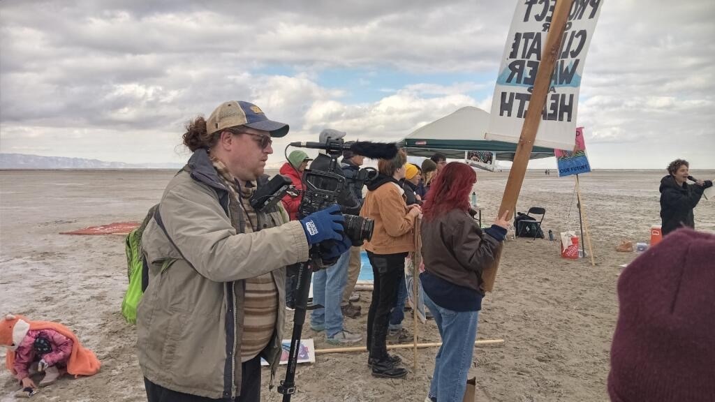 (Valene Peratrovich) Chris Kirkham, editor for the student documentary “Diverted,” captures footage of a demonstration at the Great Salt Lake on Oct. 28, 2023.