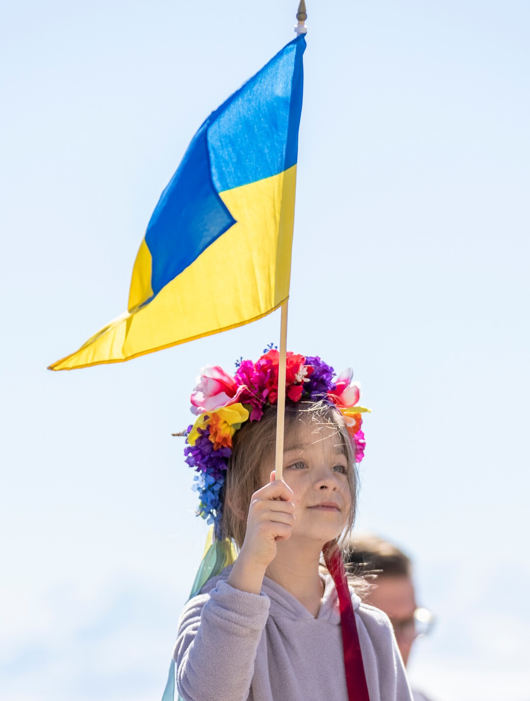 (Rick Egan | The Salt Lake Tribune) Zoriama Hansen, 8, holds a flag as Alex Boye sings, during a rally against Russia's invasion of Ukraine, organized by the Utah Ukrainian association, on Saturday, March 12, 2022.