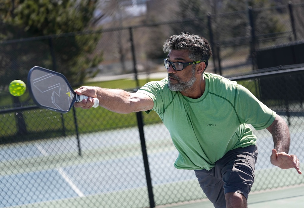 (Francisco Kjolseth | The Salt Lake Tribune) Pickleball player Parth Gandhi stretches out for a return while playing at the Fairmont Park courts in Salt Lake City on Tuesday, April 11, 2023.