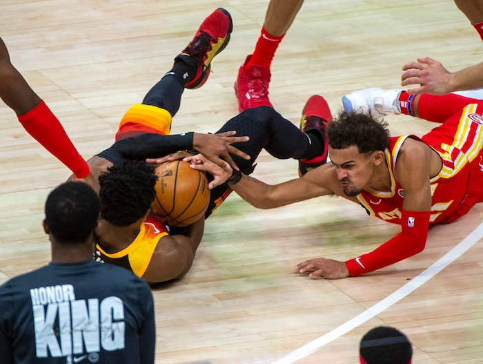 (Rick Egan | The Salt Lake Tribune) Atlanta Hawks guard Trae Young (11) goes for a loose ball along with Utah Jazz guard Donovan Mitchell (45), in NBA action between the Utah Jazz and the Atlanta Hawks at Vivint Arena, on Friday, Jan. 15, 2021.