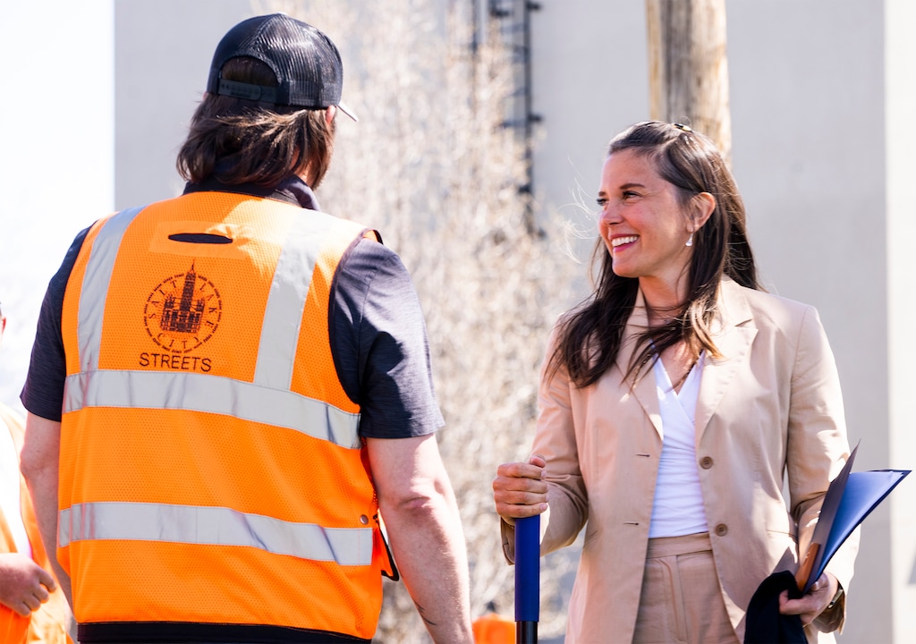 (Rick Egan | The Salt Lake Tribune)   Mayor Erin Mendenhall talks to Salt Lake City Street workers, before announcing the cities pothole palooza, road repair effort, during a news conference, on Tuesday, April 11, 2023. The salary of a mayor in Utah ranges widely and often depends on if a city is a "strong-mayor" city like Salt Lake City or a "council-manager" city.