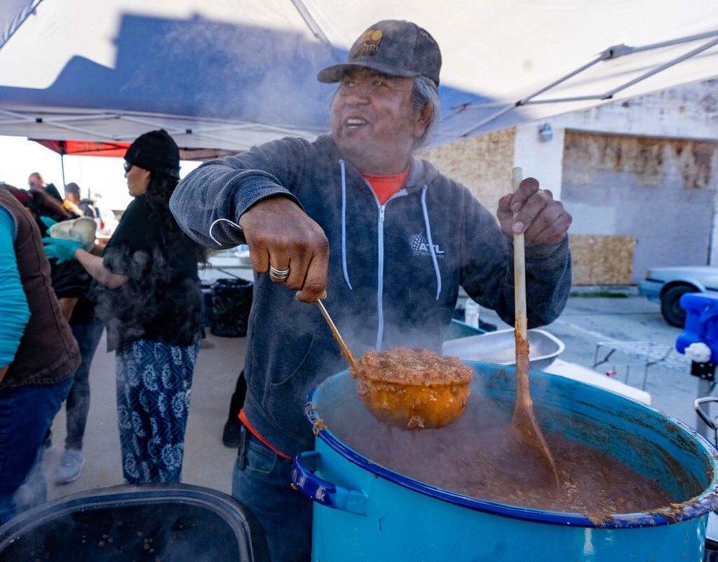 (Rick Egan | The Salt Lake Tribune) Dave John cooks up some beans for Navajo Tacos, as he teams up with Black Lives for Humanity volunteers to serve a "Gratitude Dinner" to more than 100 people from the unsheltered population, on 500 West in Salt Lake City, onThursday, Nov. 25, 2021.