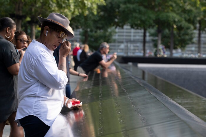 (Mark Lennihan | AP Photo) A woman wipes away tears as she stands next to the north pool prior to a ceremony marking the 18th anniversary of the attacks of Sept. 11, 2001 at the National September 11 Memorial, Wednesday, Sept. 11, 2019 in New York.