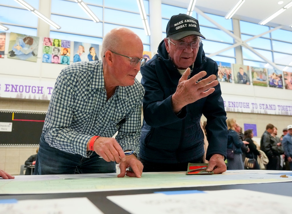 (Bethany Baker | The Salt Lake Tribune) An official looks at a precinct map with a caucusgoer ahead of the presidential primary caucuses at Riverton High School in Riverton on Tuesday, March 5, 2024.