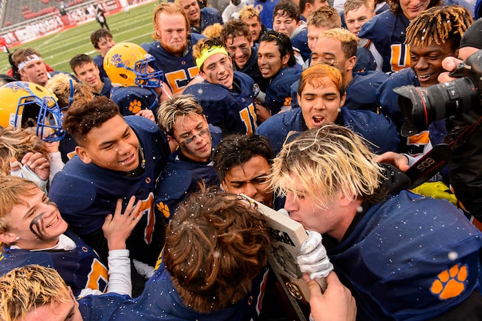 (Trent Nelson | The Salt Lake Tribune)  Orem players celebrate the win over Mountain Crest in the Class 4A High School State Football Championship game in Salt Lake City, Friday November 17, 2017.