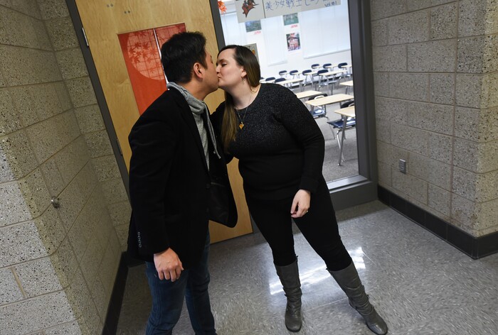 (Francisco Kjolseth  |  The Salt Lake Tribune)  Masa Fukuda, a songwriter, music arranger and director of the One Voice Children's Choir kisses his wife Alyssa Fukuda following a brief visit in her classroom at Granger High School where she teaches Japanese. Set up by a friend in July of 2015, the two married a few months later in October. 
