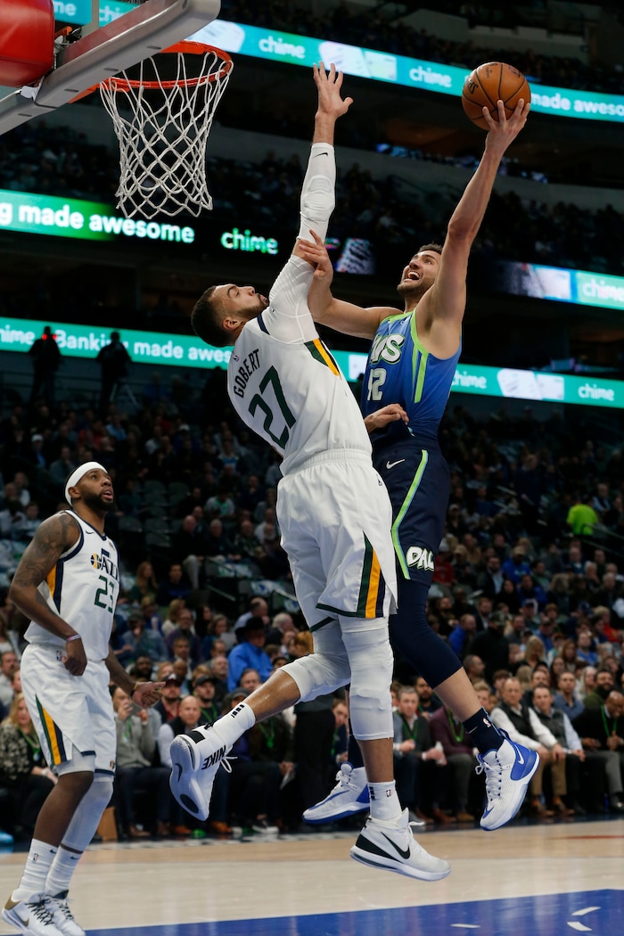 Dallas Mavericks forward Maxi Kleber (42) is defended on a shot by Utah Jazz center Rudy Gobert (27) during the first half an NBA basketball game in Dallas, Monday, Feb. 10, 2020. (AP Photo/Michael Ainsworth)