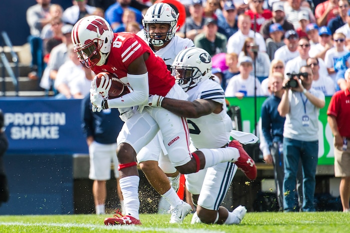 (Chris Detrick  |  The Salt Lake Tribune)   Wisconsin Badgers wide receiver Quintez Cephus (87) scores a touchdown past Brigham Young Cougars defensive back Dayan Ghanwoloku (5) and Brigham Young Cougars linebacker Butch Pau'u (38) during the game at LaVell Edwards Stadium Saturday Saturday, September 16, 2017. Wisconsin Badgers are leading Brigham Young Cougars 24-6 at halftime.