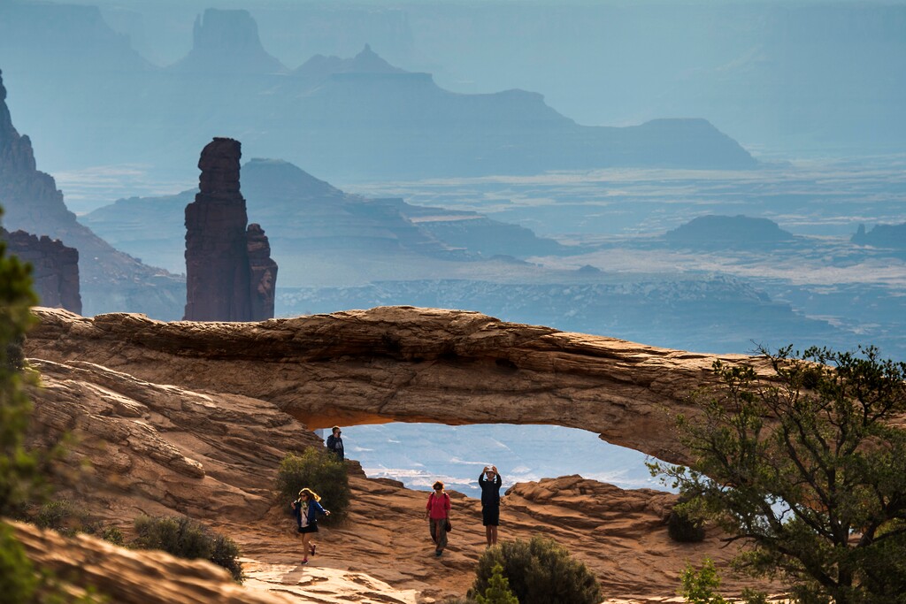 (Chris Detrick | Tribune file photo)
Visitors take pictures and gaze upon Mesa Arch in the Island in the Sky District at Canyonlands National Park Thursday August 25, 2016. Canyonlands and its sister park Arches, both near Moab, will reopen May 29 after being closed for two months in the face of the coronavirus pandemic.