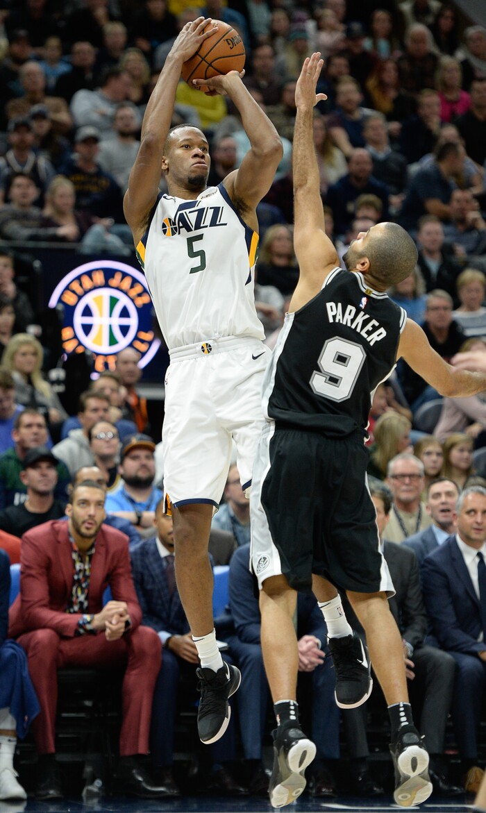 (Francisco Kjolseth  |  The Salt Lake Tribune)  Utah Jazz guard Rodney Hood (5) works his way to 29 game points as he shoots over San Antonio Spurs guard Tony Parker (9) during the second half of the NBA basketball game in Salt Lake City, Thursday, Dec. 21, 2017.