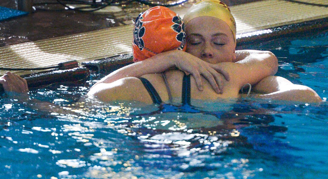 (Leah Hogsten  |  The Salt Lake Tribune)  Maple Mountain's Makayla Cazier gets a hug from Brighton's Rachel Butler after the 500 yard freestyle at the Class 5A State Championships in Bountiful, Saturday, February 10, 2018. 