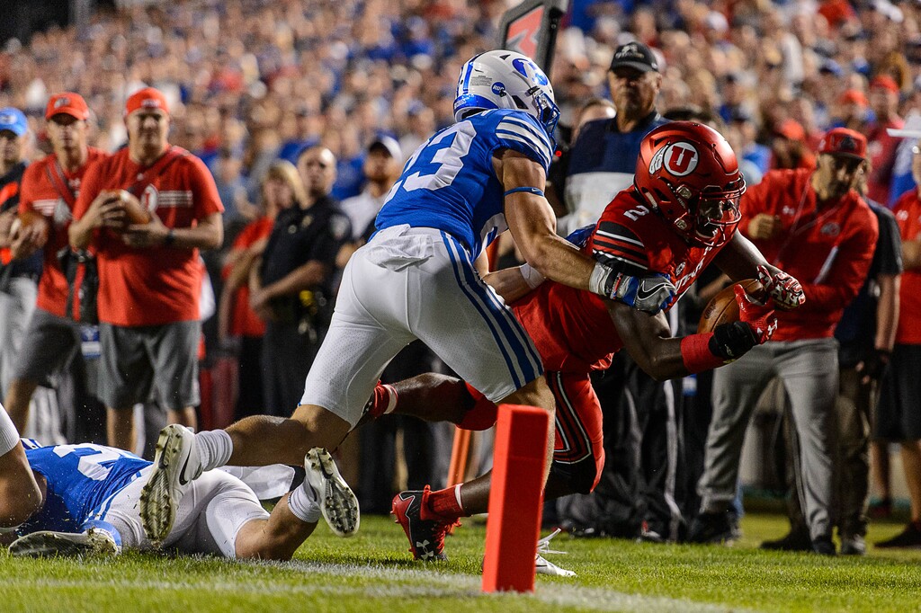 (Trent Nelson | The Salt Lake Tribune)  Utah Utes running back Zack Moss (2) is pushed out of bounds by Brigham Young Cougars defensive back Zayne Anderson (23) just short of the end zone as BYU hosts Utah, NCAA football in Provo, Saturday September 9, 2017.