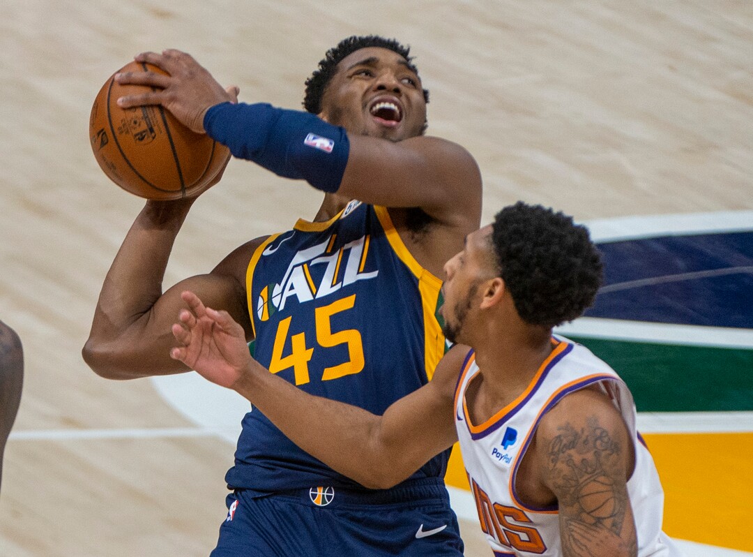 (Rick Egan | The Salt Lake Tribune) Phoenix Suns guard Cameron Payne (15) is called for a foul as he collides with Jazz guard Donovan Mitchell (45), in NBA action between the Utah Jazz and the Phoenix Suns, on Thursday, Dec. 31, 2020.