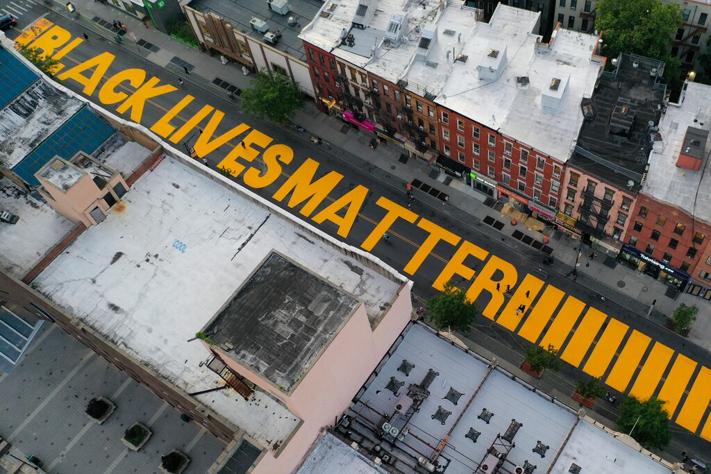 (John Minchillo | AP file photo)  A giant "BLACK LIVES MATTER" sign is painted on Fulton Street, Monday, June 15, 2020, in the Brooklyn borough of New York.