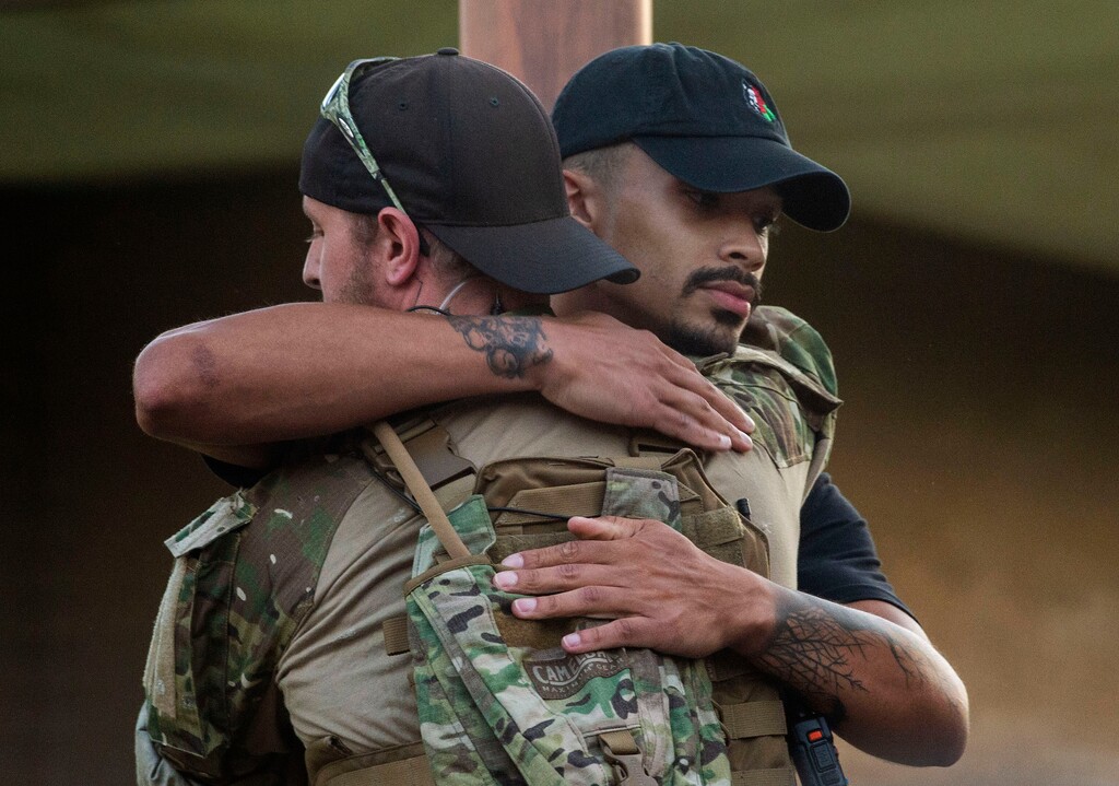 (Rick Egan  |  The Salt Lake Tribune)  Black Lives Matter protest organizer John Sullivan, hugs one of the armed Keepers of Liberty, after inviting him to come up and say a few words during a demonstration on Center Street in Provo, Wednesday July 1, 2020.