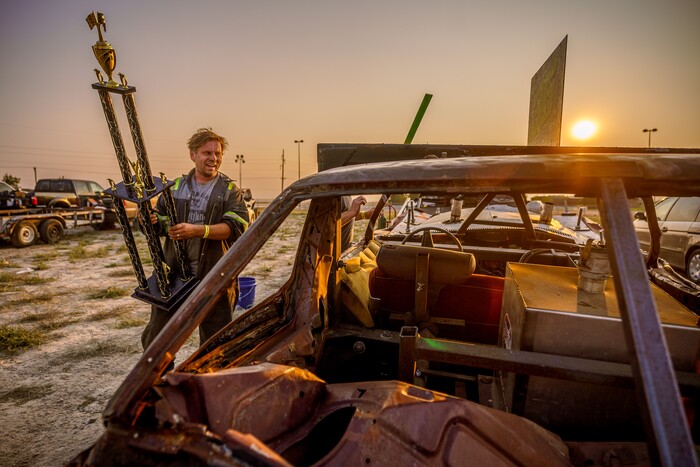 (Trent Nelson  |  The Salt Lake Tribune) Randy Makowsky of Alaska holds his first place trophy in the stock competition at Punishment at the Peak, a demolition derby in Grantsville on Saturday, Aug. 7, 2021.