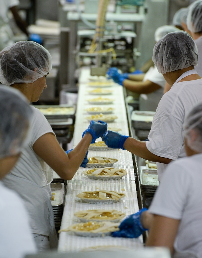 Francisco Kjolseth | The Salt Lake Tribune
Workers assemble hand laid lattice apple pies at Rocky Mountain Pie factory in Salt Lake recently. Eight different pies sold through Associated Food Stores earned blue ribbons in the commercial categories at the National Pie Championships.