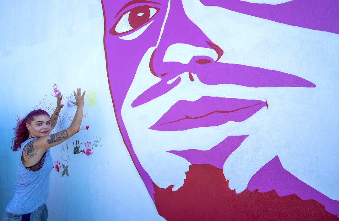 (Rick Egan | The Salt Lake Tribune) Tesha Taylor, Dillon's sister puts her hand prints on the all, next to the mural of her brother, Dillon Taylor, who was shot by the police 7 years ago, during a memorial for Dillon, on Wednesday, Aug. 11, 2021.