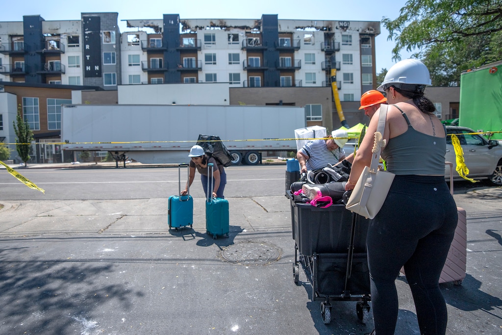 (Rick Egan | The Salt Lake Tribune) Renters bring their belongings out of the North Union Apartments, which burned last week, in Midvale.