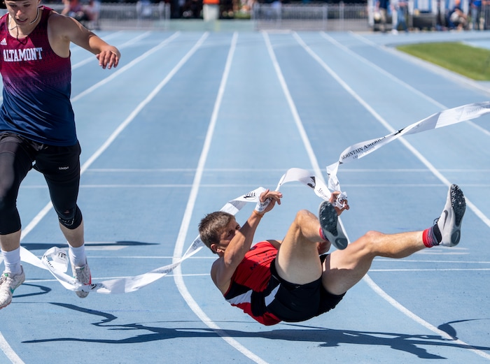 (Rick Egan | The Salt Lake Tribune)  Altamont's Ethan Hansen finishes in second place as Blake Barnes dives headfirst into the finish line for a first place finish in the 1A Boys 200 meter dash, at the State High School Championships at BYU, on Saturday, May 21, 2022.
