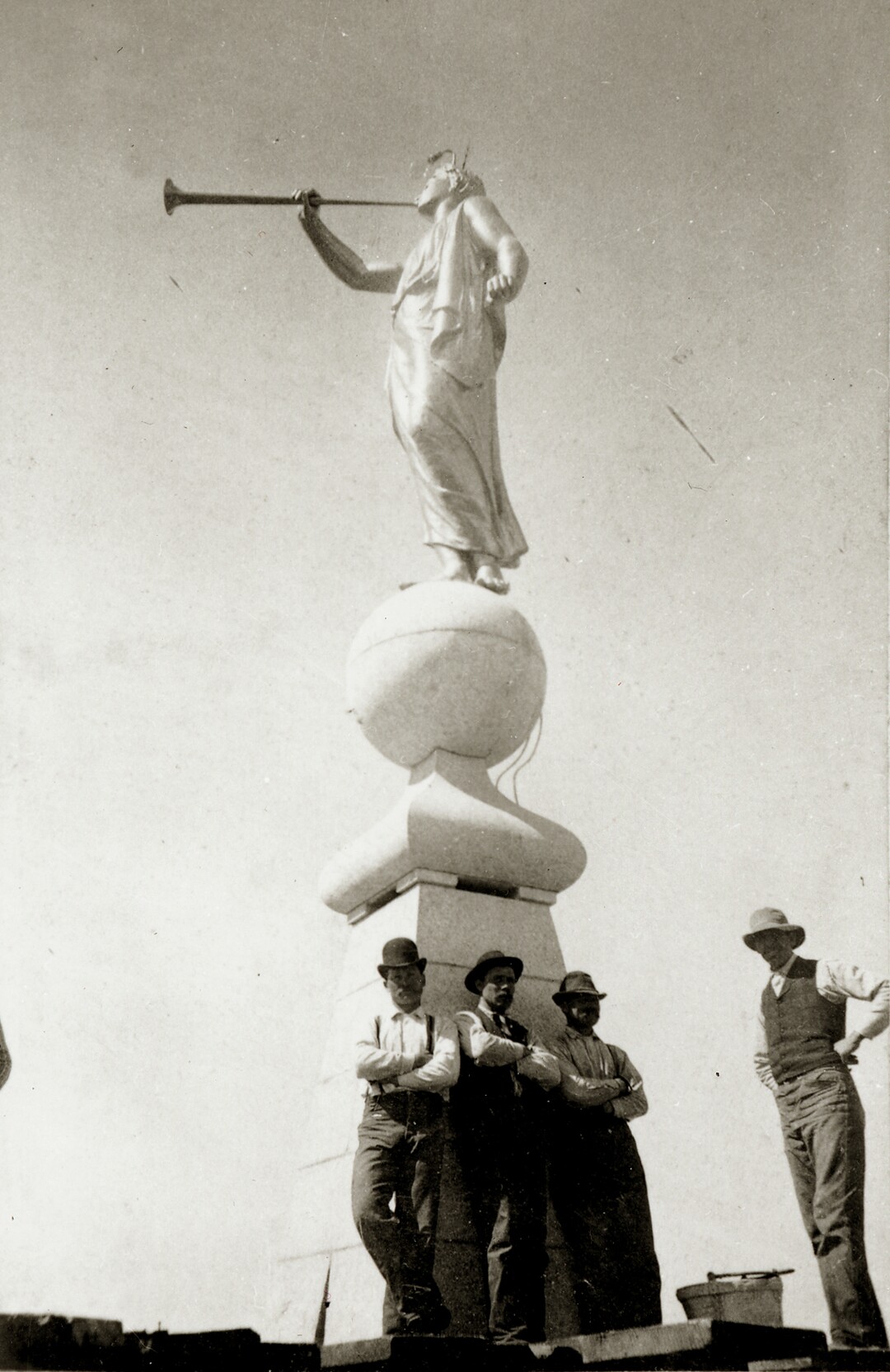 (photo courtesy The Church of Jesus Christ of Latter-day Saints) Workers stand atop the Salt Lake Temple before the placement of the capstone in April 1892.