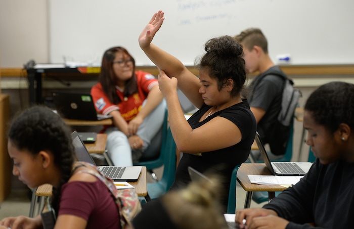 (Francisco Kjolseth  |  The Salt Lake Tribune)  Joanna Guerrero raises her hand to ask a question in English class at Hillcrest High school in Midvale as part of a summer program. Students who participate in the Husky Strong summer school program receive $5 a day to get a head start on the school year.