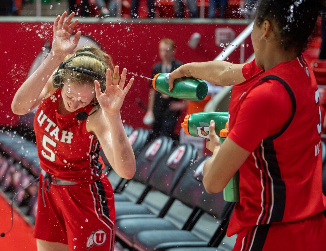 (Rick Egan | The Salt Lake Tribune) Utah Utes guard Lani White (3) sprays Utah guard Gianna Kneepkens (5) as they celebrate their win over the Stanford Cardinals in PAC-12 action at the Jon M. Huntsman Center, on Saturday, Feb. 25, 2023.