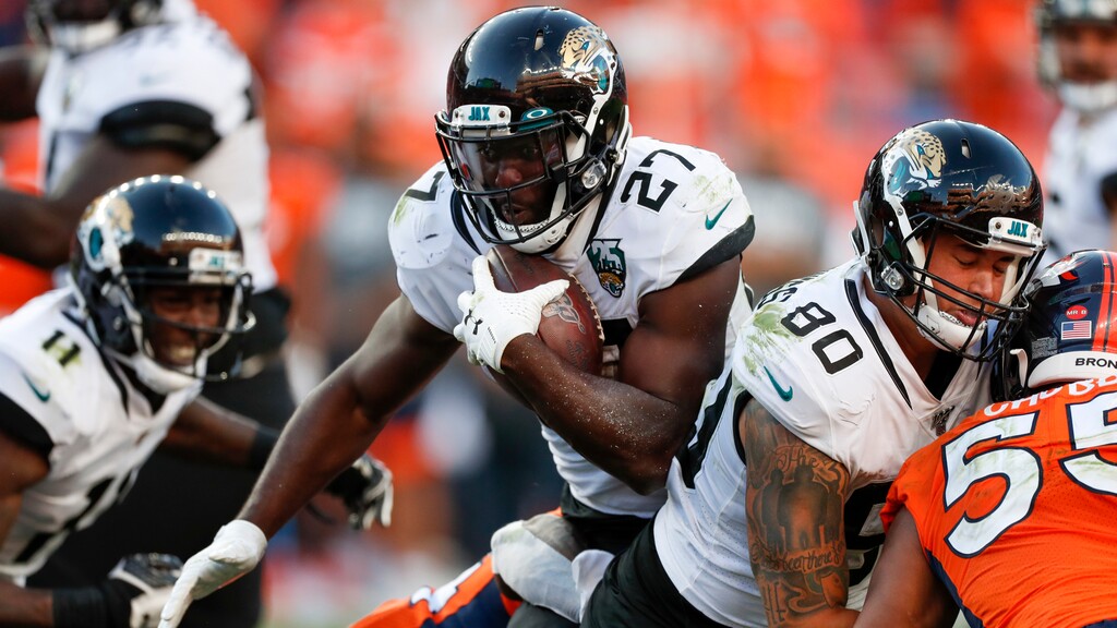Jacksonville Jaguars running back Leonard Fournette, center, runs with the ball during the second half of an NFL football game against the Denver Broncos, Sunday, Sept. 29, 2019, in Denver. (AP Photo/David Zalubowski)