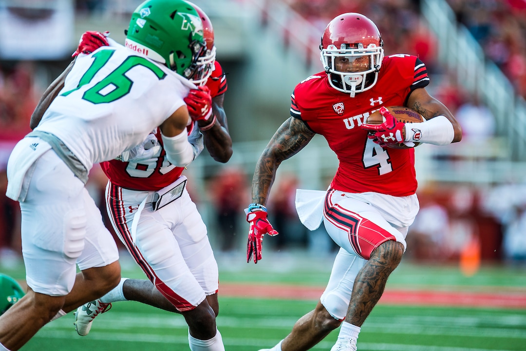 (Chris Detrick  |  The Salt Lake Tribune)  Utah Utes wide receiver Troy McCormick Jr. (4) runs past North Dakota Fighting Hawks defensive back Torrey Hunt (16) during the game at Rice-Eccles Stadium Thursday, August 31, 2017. Utah Utes are leading North Dakota Fighting Hawks 17-9 at halftime. 