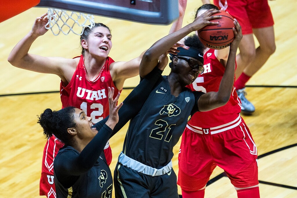 (Chris Detrick  |  The Salt Lake Tribune) Colorado Buffaloes guard/forward Mya Hollingshed (21) grabs a rebound past Utah Utes forward Emily Potter (12) during the game at the Huntsman Center Thursday, Feb. 1, 2018.