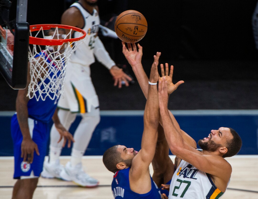 (Rick Egan | The Salt Lake Tribune) Utah Jazz center Rudy Gobert (27) goes to the basket, as LA Clippers forward Nicolas Batum (33) defends, from scoring, in NBA action between the Utah Jazz and the LA Clippers at Vivint Arena, on Friday, Jan. 1, 2021.