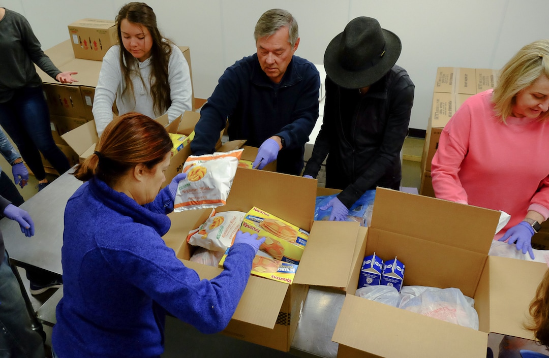 (Francisco Kjolseth  |  The Salt Lake Tribune) The community comes together during the coronavirus outbreak on Saturday, March 14, 2020, after hearing the Utah Food Bank is hurting for volunteers, since groups that normally volunteer canceled after the order of mass gatherings.