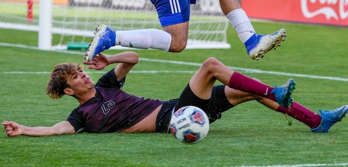 (Leah Hogsten | The Salt Lake Tribune) Real's Jesus Cruz leaps over Layton's Joao Gallo as Real Salt Lake Academy meets Layton Christian Academy for the 3A State Soccer Championship title at Rio Tinto Stadium, Wednesday, May 11, 2022. Layton Christian Academy won the title 4-0. 
