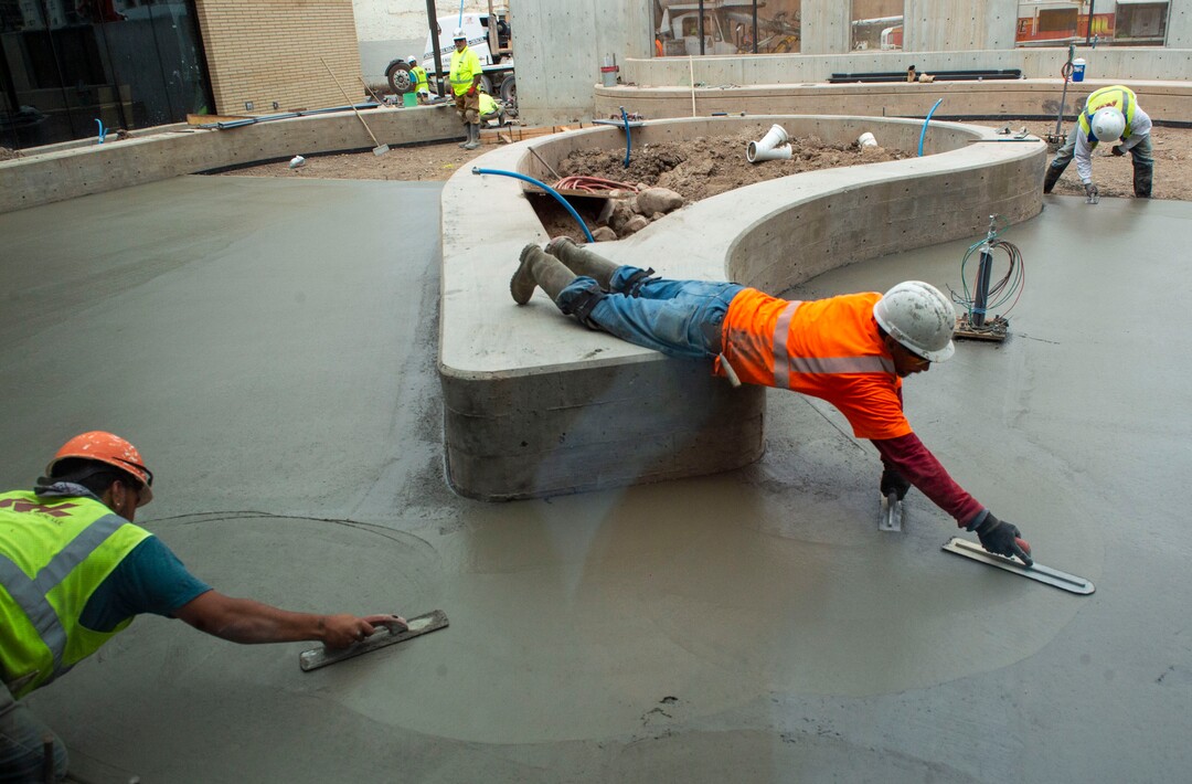 (Rick Egan  |  The Salt Lake Tribune) Construction workers smooth the cement at the Geraldine E. King WomenÕs Resource Center on 700 South in Salt Lake City, Friday, June 14, 2019.