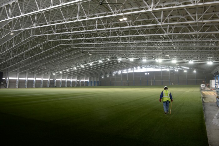 (Al Hartmann  |  The Salt Lake Tribune) 	
Workers finish laying artificial surface for the  RSL Academy charter school's indoor soccer arena.  It's huge. Housing two side by side soccer fields, seating and a concessions area.  It's believed to be the largest pre-fabricated single span building in the world.  It will open mid January 2018.  