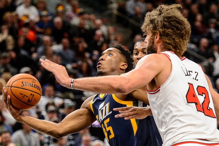 (Trent Nelson | The Salt Lake Tribune)  Utah Jazz guard Donovan Mitchell (45) shoots past Chicago Bulls center Robin Lopez (42) as the Utah Jazz host the Chicago Bulls, NBA basketball in Salt Lake City Wednesday November 22, 2017.